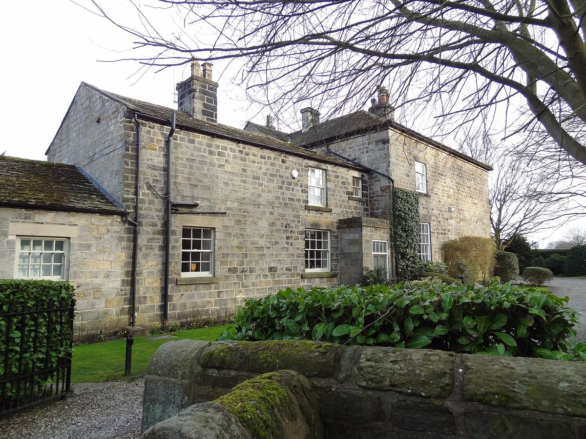 Stone farmhouse with a stone slate roof and two chimney stacks